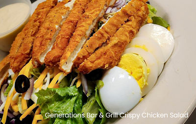 A plate featuring Generations Bar Grill's crispy chicken salad topped with slices of hardboiled egg.